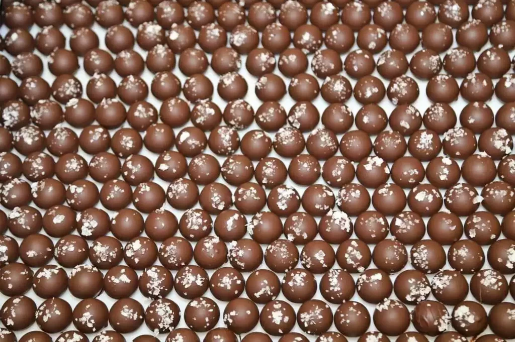 Close-up of a tray full of salt caramel truffle chocolates.