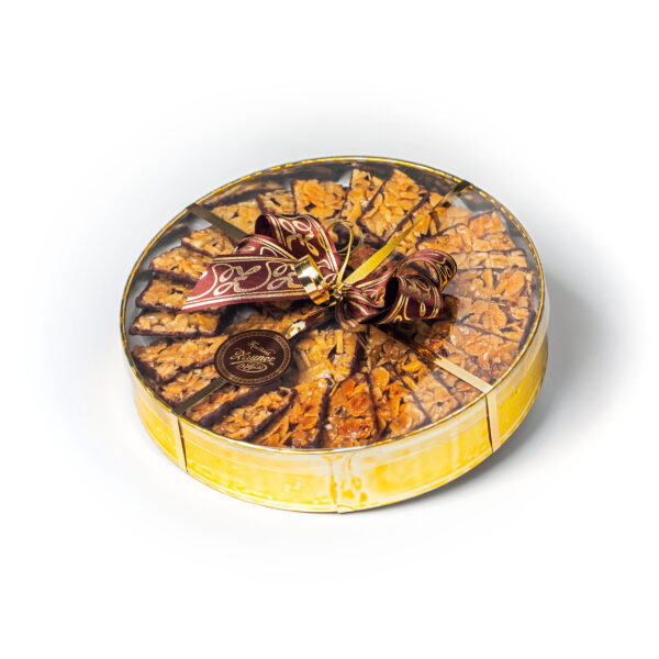 Round gift box in gold, filled with Florentines from the Zauner confectionery