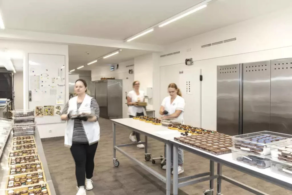 Snapshot of the bakery - employees going about their daily work.