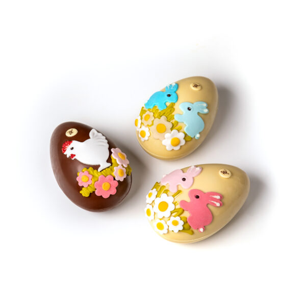 Hand-decorated chocolate eggs in white and light chocolate, each weighing 290g