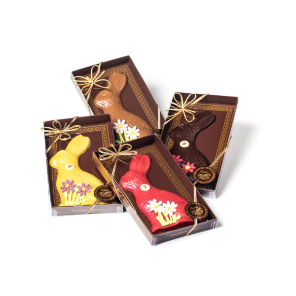 Four brown gift boxes with Easter bunnies made of different chocolates