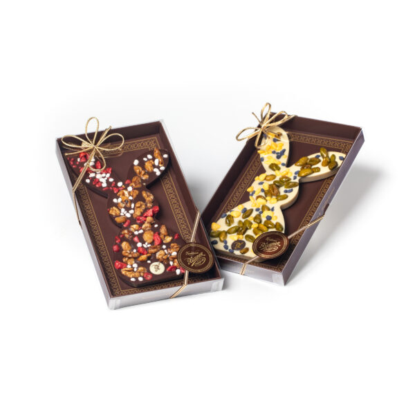 Two brown gift boxes with sprinkled Easter bunnies made of white and dark chocolate